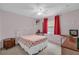 Bedroom with floral bedding and a convenient workspace at 2712 Ceram Ave, Orlando, FL 32837