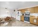 Kitchen featuring wood cabinets, a dining area, and white appliances at 2712 Ceram Ave, Orlando, FL 32837