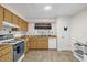 Kitchen with wood cabinets, white appliances, and tile flooring at 2712 Ceram Ave, Orlando, FL 32837