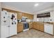 Kitchen featuring wood cabinets, white appliances, and tile flooring at 2712 Ceram Ave, Orlando, FL 32837