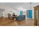 Living room with teal sofa, armchairs, and wood-look flooring at 2712 Ceram Ave, Orlando, FL 32837