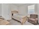 Cozy bedroom with a full bed and armchair at 283 Archer Way, Haines City, FL 33844