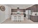 Modern kitchen with dark cabinetry, granite countertops, and an island at 283 Archer Way, Haines City, FL 33844