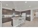 Modern kitchen with dark cabinetry, granite countertops, and stainless steel appliances at 283 Archer Way, Haines City, FL 33844