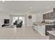 Open concept living room and kitchen with tile flooring and neutral colors at 283 Archer Way, Haines City, FL 33844