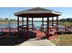 Picturesque gazebo on a lakeside dock, offering a tranquil spot for relaxation and reflection at 2949 Sunset Vista Blvd, Kissimmee, FL 34747