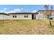 Large backyard with grassy area and sliding glass door access at 3037 Cassidy Ln, Haines City, FL 33844