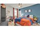 Bedroom with burnt orange bedding and blue accent wall at 3037 Cassidy Ln, Haines City, FL 33844