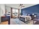 Bright bedroom with dark blue accent wall and a comfortable bed at 3037 Cassidy Ln, Haines City, FL 33844