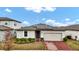 One-story house with solar panels and a brick driveway at 3037 Cassidy Ln, Haines City, FL 33844