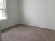 This cozy bedroom features neutral carpet and a window with natural light at 329 Conway Ave, St Cloud, FL 34771