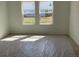 Bright bedroom with carpeted floor, freshly painted walls, and two large windows at 329 Conway Ave, St Cloud, FL 34771
