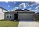 Single-story home features a two car garage and well-maintained lawn at 329 Conway Ave, St Cloud, FL 34771