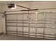 Spacious garage with a functional door and lighting system for easy access and security at 329 Conway Ave, St Cloud, FL 34771