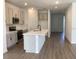 Open kitchen boasts a large island, stainless steel appliances, and sleek countertops at 329 Conway Ave, St Cloud, FL 34771