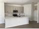 Spacious kitchen with white cabinetry, an island with sink, and stainless steel microwave at 329 Conway Ave, St Cloud, FL 34771