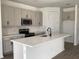 Modern kitchen with an island, sleek countertops, stainless steel appliances, and white cabinetry at 329 Conway Ave, St Cloud, FL 34771