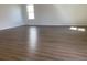 Large living room with wood flooring and bright windows at 329 Conway Ave, St Cloud, FL 34771