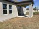 View of a covered patio with a concrete floor and neutral colored stucco walls, and a transitional outdoor area at 329 Conway Ave, St Cloud, FL 34771