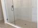 Glass-enclosed shower with tiled walls and floor, featuring a modern showerhead at 329 Conway Ave, St Cloud, FL 34771