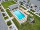 Community pool with surrounding patio and lush landscaping at 335 N Causeway # C23, New Smyrna Beach, FL 32169
