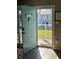 Inviting teal front door opens to a view of the community at 335 N Causeway # C23, New Smyrna Beach, FL 32169