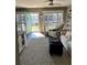Bright living room with comfy seating, stylish rug, and access to a patio at 335 N Causeway # C23, New Smyrna Beach, FL 32169