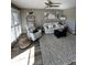 Bright living room features comfy seating, large windows, and stylish decor at 335 N Causeway # C23, New Smyrna Beach, FL 32169
