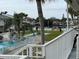 Relaxing view of the community pool, canal, and green lawn from a balcony at 335 N Causeway # C23, New Smyrna Beach, FL 32169