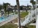 Steps leading to a community pool and canal view with lush landscaping at 335 N Causeway # C23, New Smyrna Beach, FL 32169