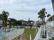 Community pool and canal view with lush landscaping and palm trees at 335 N Causeway # C23, New Smyrna Beach, FL 32169