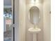 Small bathroom with pedestal sink and oval mirror at 4052 Falling Lilly Ct, Winter Springs, FL 32708