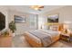 Bedroom with wood platform bed, window and ceiling fan at 4052 Falling Lilly Ct, Winter Springs, FL 32708