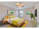 Bright bedroom with wood bed frame and yellow bedding at 4052 Falling Lilly Ct, Winter Springs, FL 32708