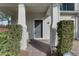 Townhome's front entrance with gray door and brick walkway at 4052 Falling Lilly Ct, Winter Springs, FL 32708