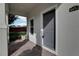 Covered front porch with gray door and brick flooring at 4052 Falling Lilly Ct, Winter Springs, FL 32708