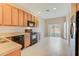 Kitchen with wood cabinets, black appliances, and tile floor at 4052 Falling Lilly Ct, Winter Springs, FL 32708