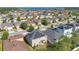 Aerial view of a residential neighborhood with solar panels, a large lake, and mature trees at 445 Kestrel Dr, Groveland, FL 34736