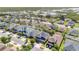 A high angle view of a neighborhood with diverse homes near a vast marshland at 445 Kestrel Dr, Groveland, FL 34736