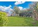 Expansive backyard featuring a well-manicured lawn and privacy fencing, creating a serene outdoor space at 445 Kestrel Dr, Groveland, FL 34736