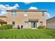 Beautiful backyard with lush green lawn and well-maintained landscaping, perfect for outdoor activities at 445 Kestrel Dr, Groveland, FL 34736