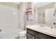Bright bathroom featuring a shower and tub combination, decorative shelves, and neutral-toned walls at 445 Kestrel Dr, Groveland, FL 34736