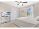 Comfortable bedroom with natural light, neutral tones, and a ceiling fan at 445 Kestrel Dr, Groveland, FL 34736