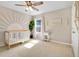 Bright Bedroom with a crib, natural light, and unique wall decor at 445 Kestrel Dr, Groveland, FL 34736