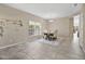 Bright dining room with a chandelier, neutral walls, and tile flooring at 445 Kestrel Dr, Groveland, FL 34736
