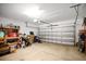 Large garage with ample storage space, shelving, and a functional workspace at 445 Kestrel Dr, Groveland, FL 34736