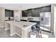 Stylish kitchen with dark wood cabinets, stainless steel appliances, and bright countertops at 445 Kestrel Dr, Groveland, FL 34736