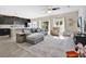 Bright open-concept living room with modern furniture and a view into the kitchen at 445 Kestrel Dr, Groveland, FL 34736