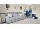 Comfortable living room area with a couch, computer setup, and neutral colors at 445 Kestrel Dr, Groveland, FL 34736