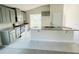 Modern kitchen with gray cabinets, granite countertops, and stainless steel appliances at 4450 Sagefield Dr, Harmony, FL 34773